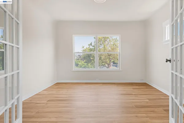 wooden floor in an empty room with a window