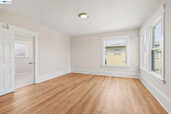 a view of an empty room with wooden floor