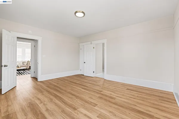 wooden floor in an empty room with a window