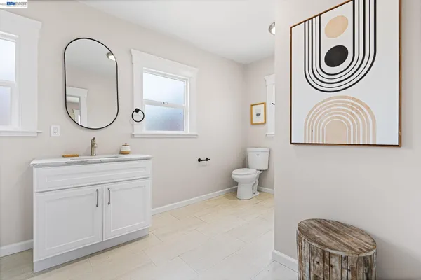 a white toilet sitting next to a bathroom sink