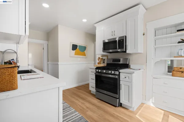 a kitchen with stainless steel appliances granite countertop a sink stove and cabinets