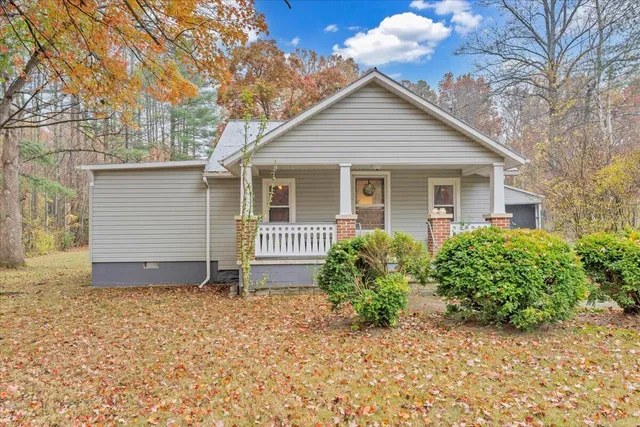 a front view of house with yard and trees around