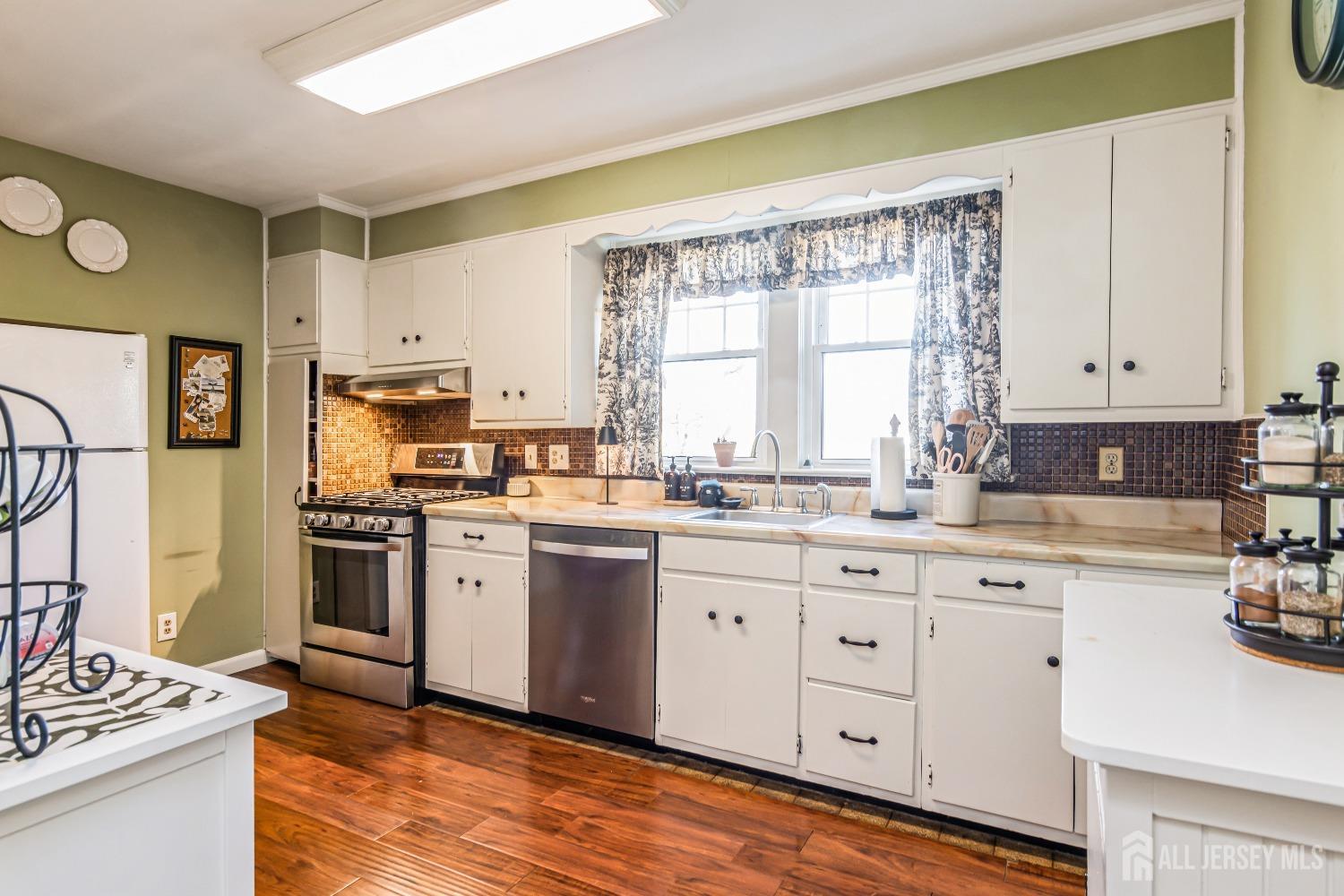 25 Simpson Avenue Edison, NJ 08817 - Photo 11 of 25 a kitchen with granite countertop white cabinets and white appliances