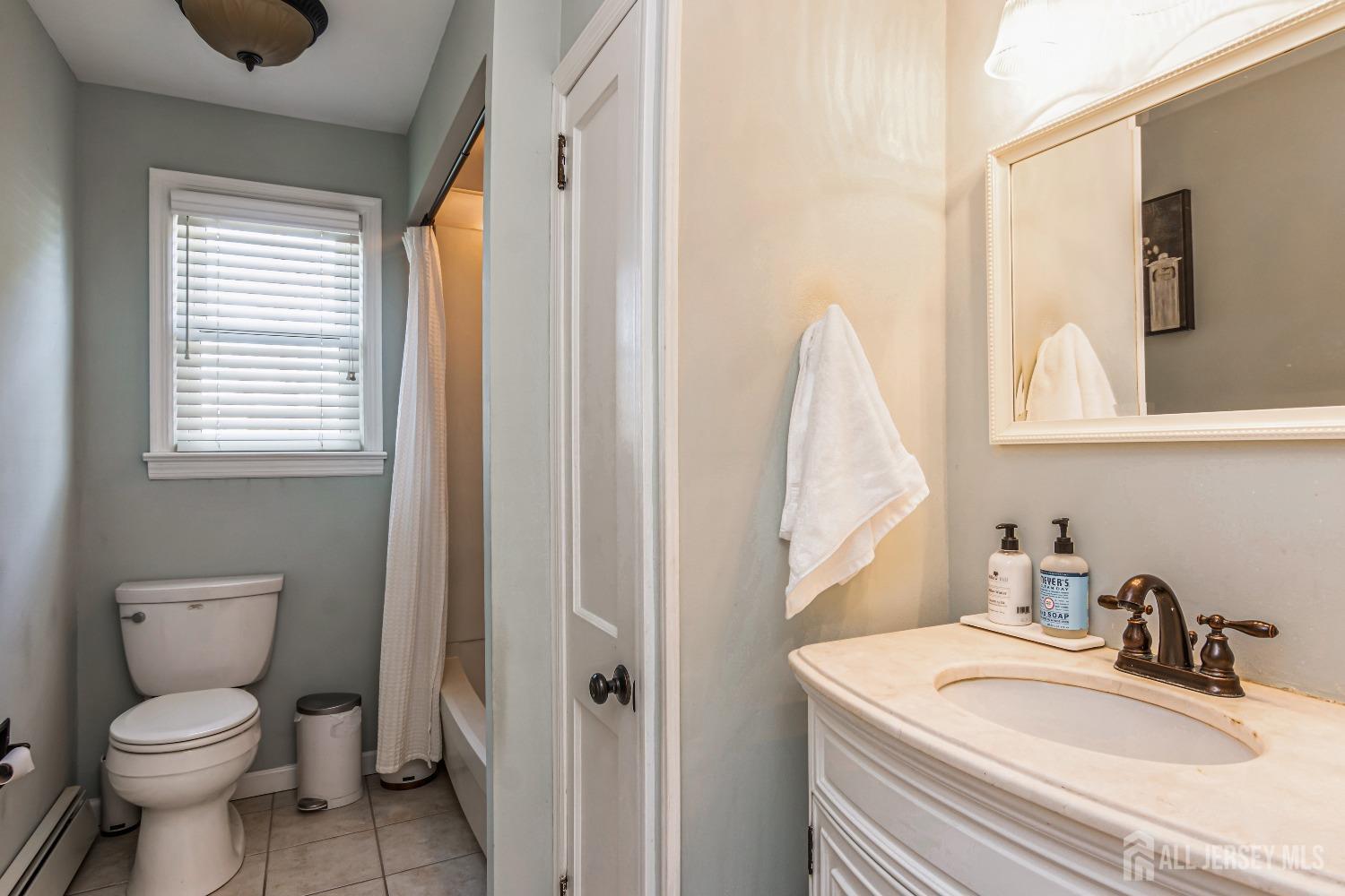 25 Simpson Avenue Edison, NJ 08817 - Photo 18 of 25 a bathroom with a sink toilet and window