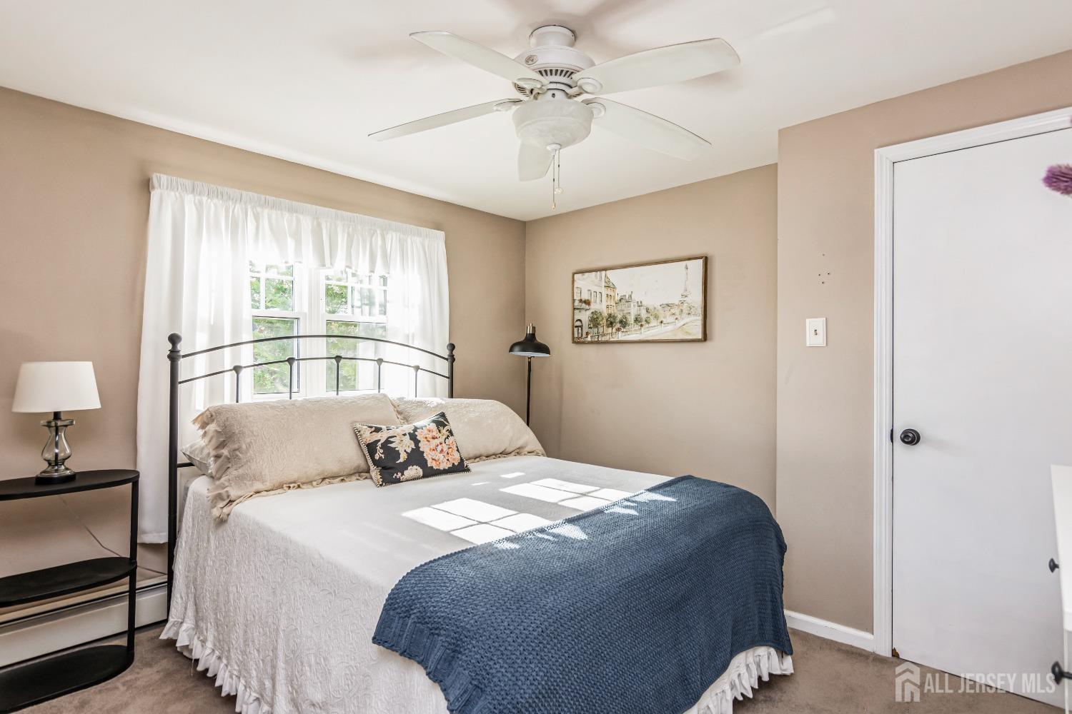 25 Simpson Avenue Edison, NJ 08817 - Photo 19 of 25 a bedroom with a large bed and a chandelier