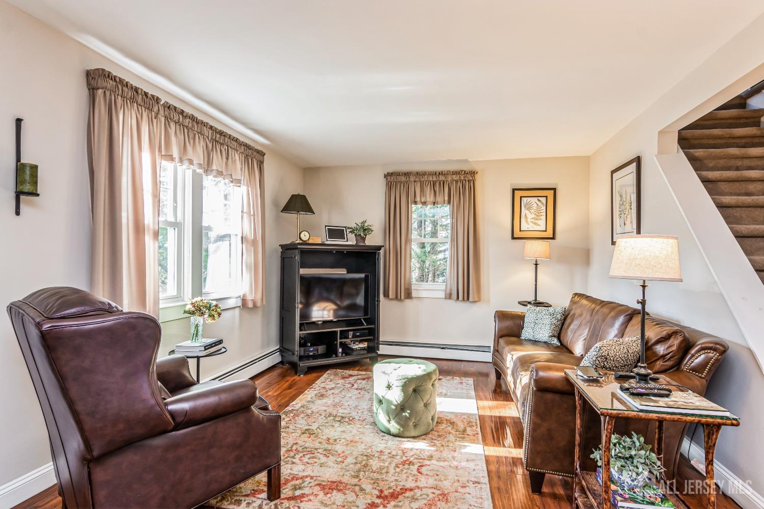 25 Simpson Avenue Edison, NJ 08817 - Photo 3 of 25 a living room with furniture a fireplace and a flat screen tv