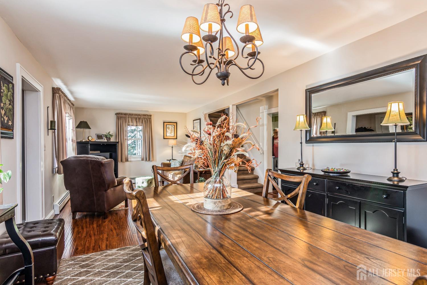 25 Simpson Avenue Edison, NJ 08817 - Photo 6 of 25 a view of a dining room with furniture a kitchen and chandelier