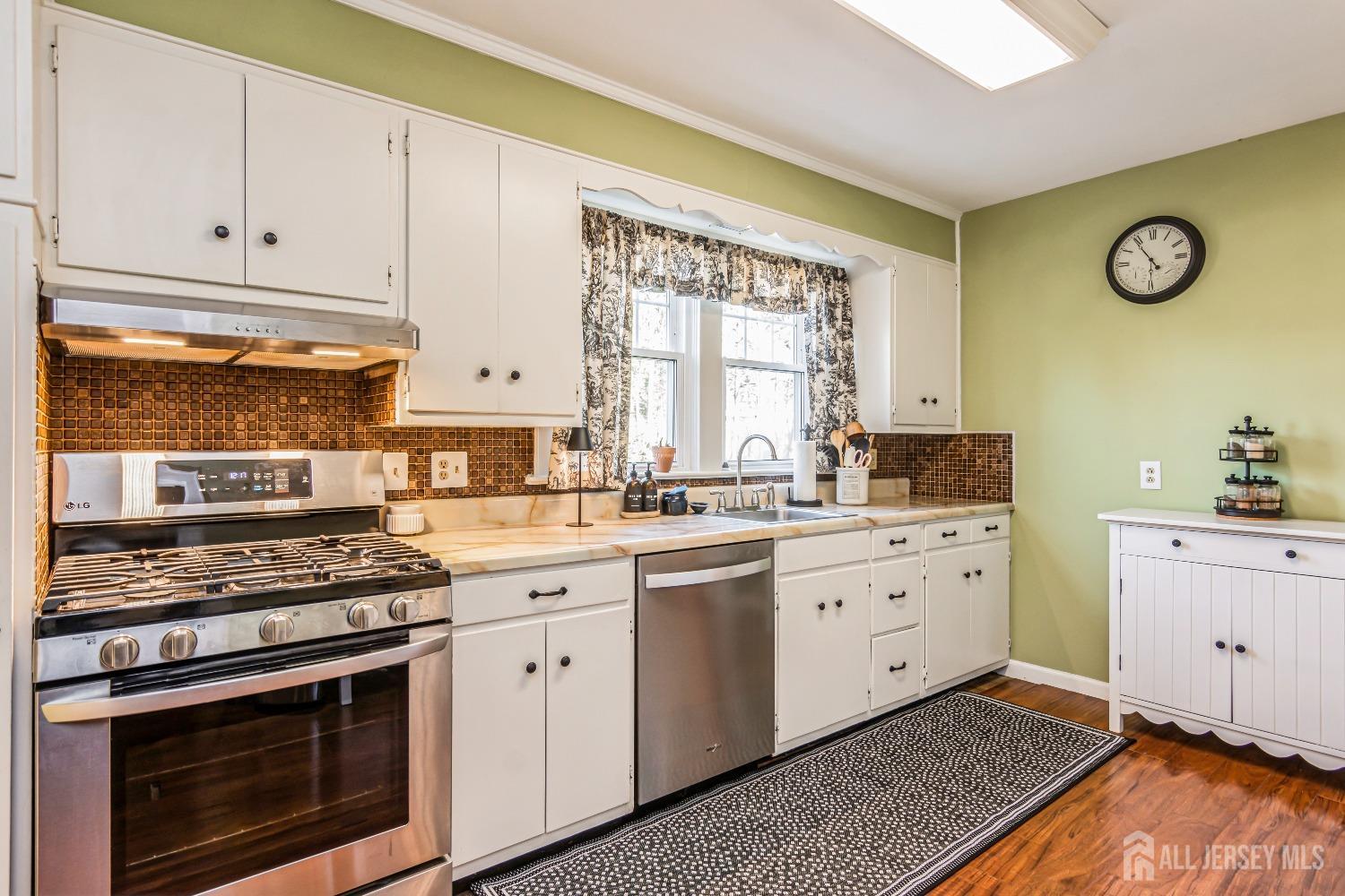 25 Simpson Avenue Edison, NJ 08817 - Photo 7 of 25 a kitchen with granite countertop cabinets stainless steel appliances and a window
