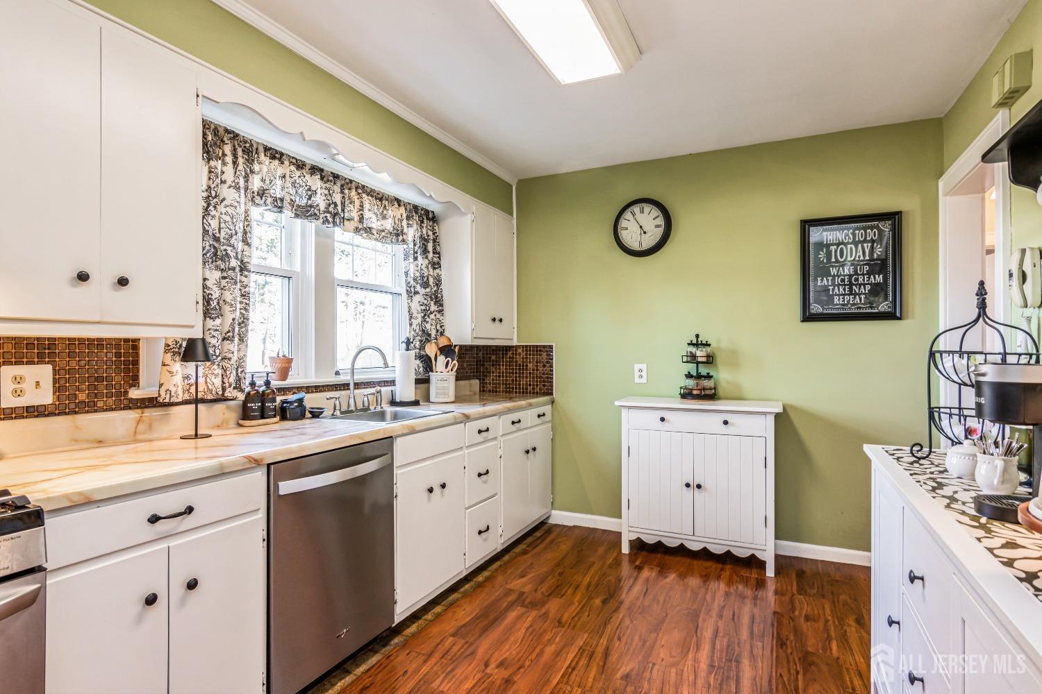 25 Simpson Avenue Edison, NJ 08817 - Photo 9 of 25 a kitchen with cabinets a window and stainless steel appliances