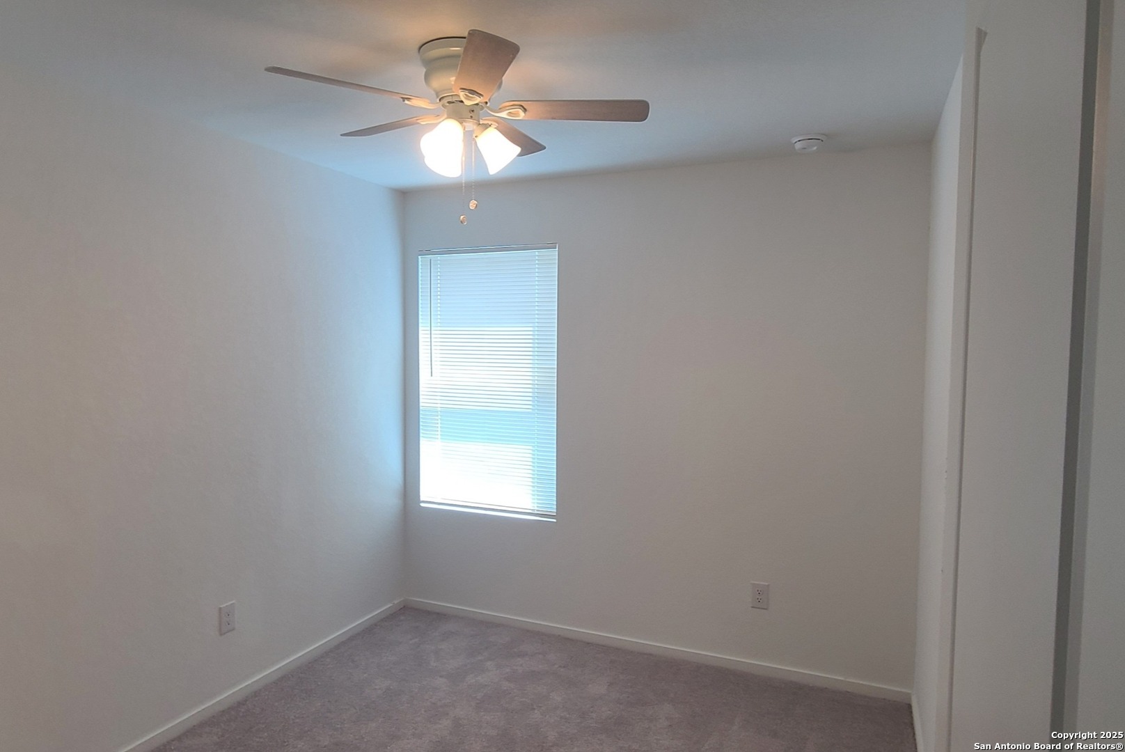 4965 Daisy Blossom Converse, TX 78109 - Photo 18 of 23 an empty room with a window and a fan