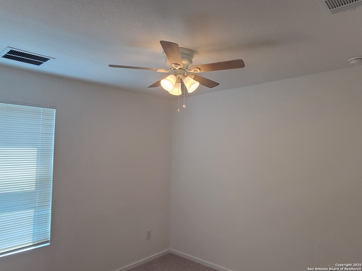 4965 Daisy Blossom Converse, TX 78109 - Photo 19 of 23 a light fixture a ceiling fan and a window