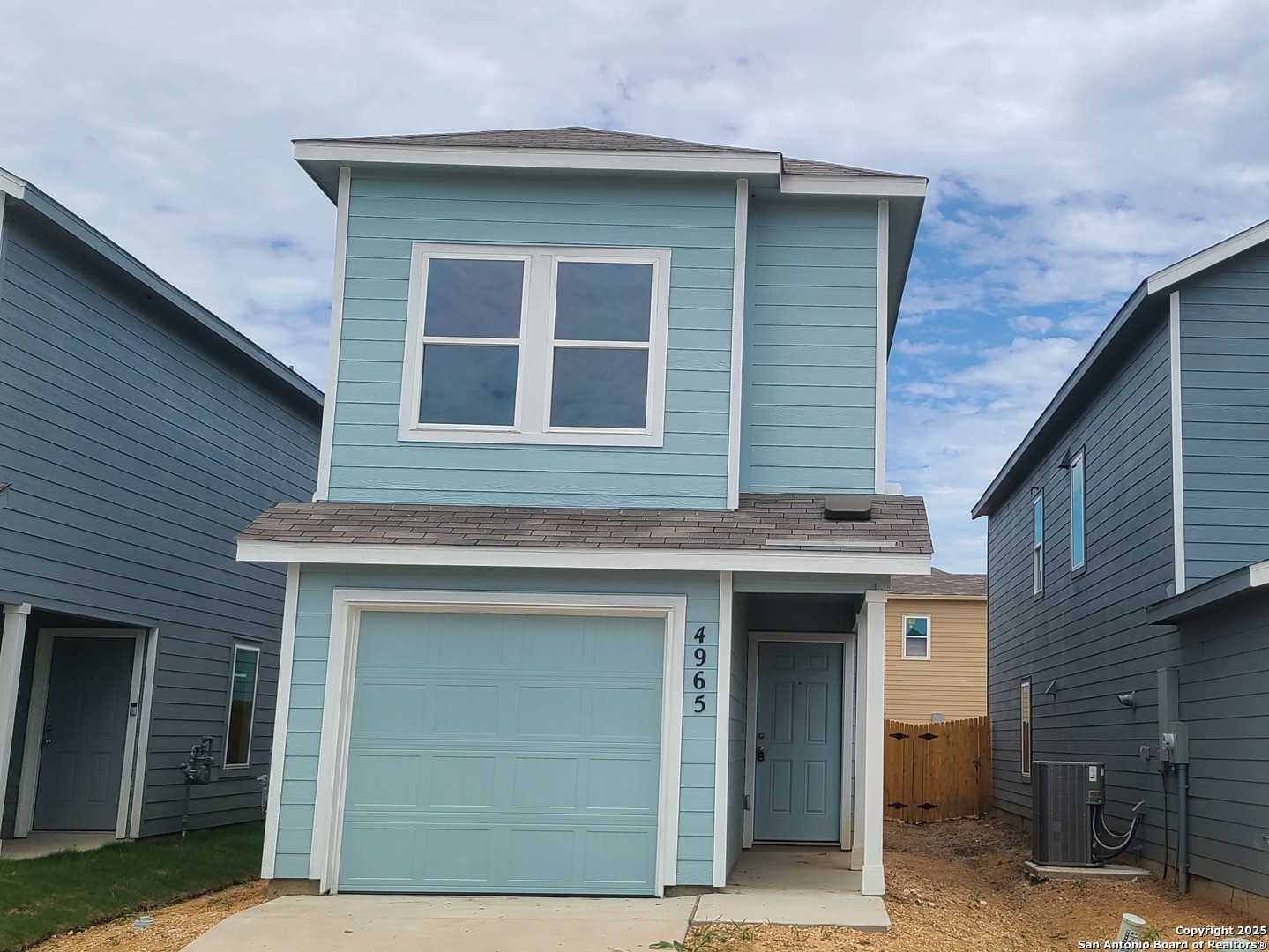4965 Daisy Blossom Converse, TX 78109 - Photo 3 of 23 a front view of a house with a garage