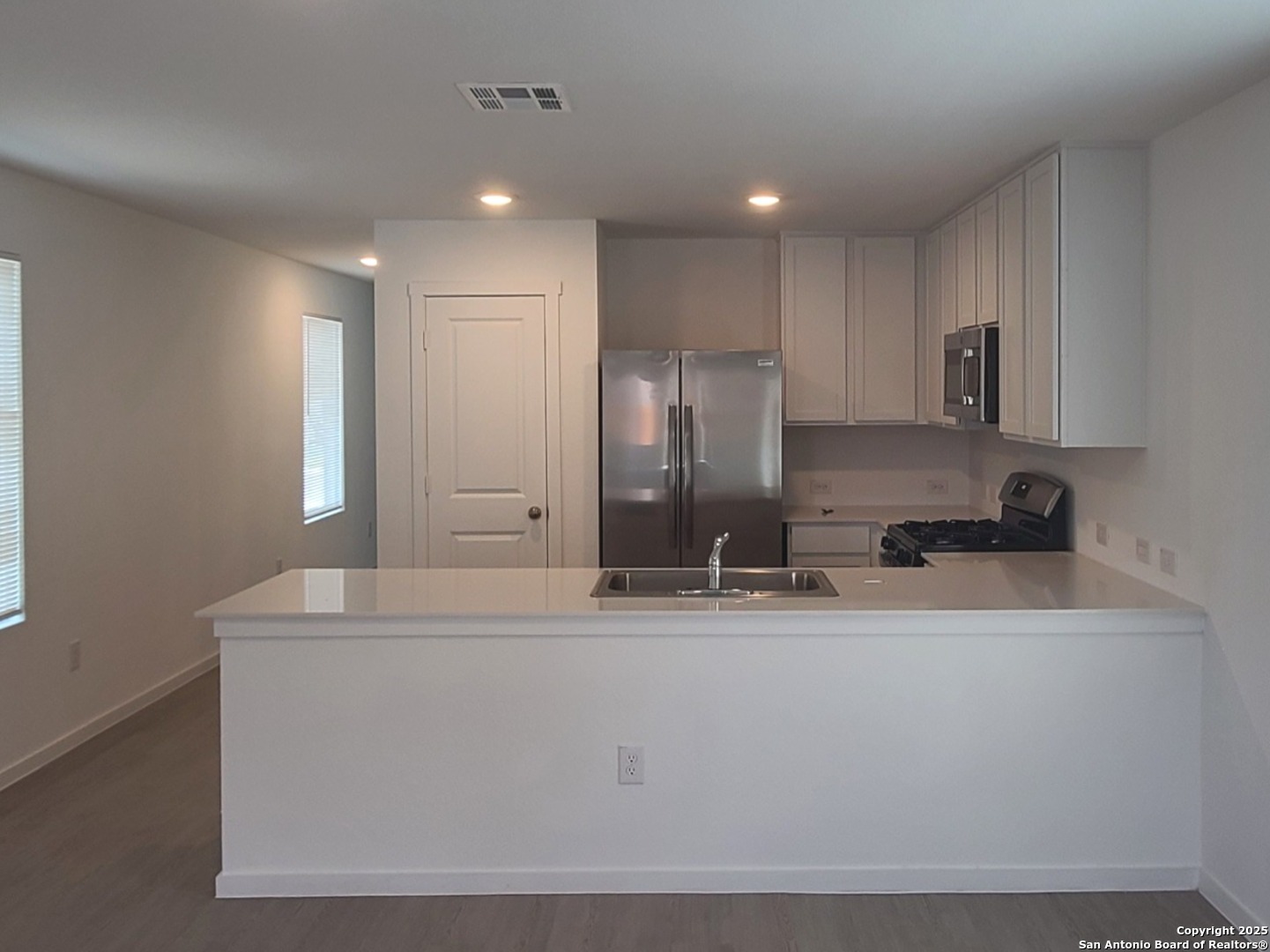 4965 Daisy Blossom Converse, TX 78109 - Photo 5 of 23 a kitchen with kitchen island sink stove and refrigerator