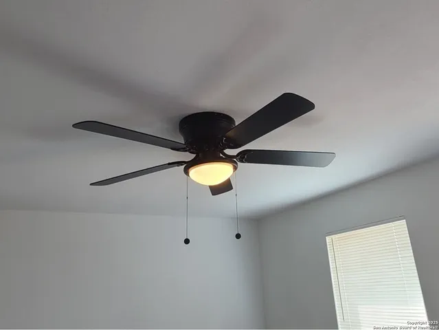 an empty room with a window and wooden floor