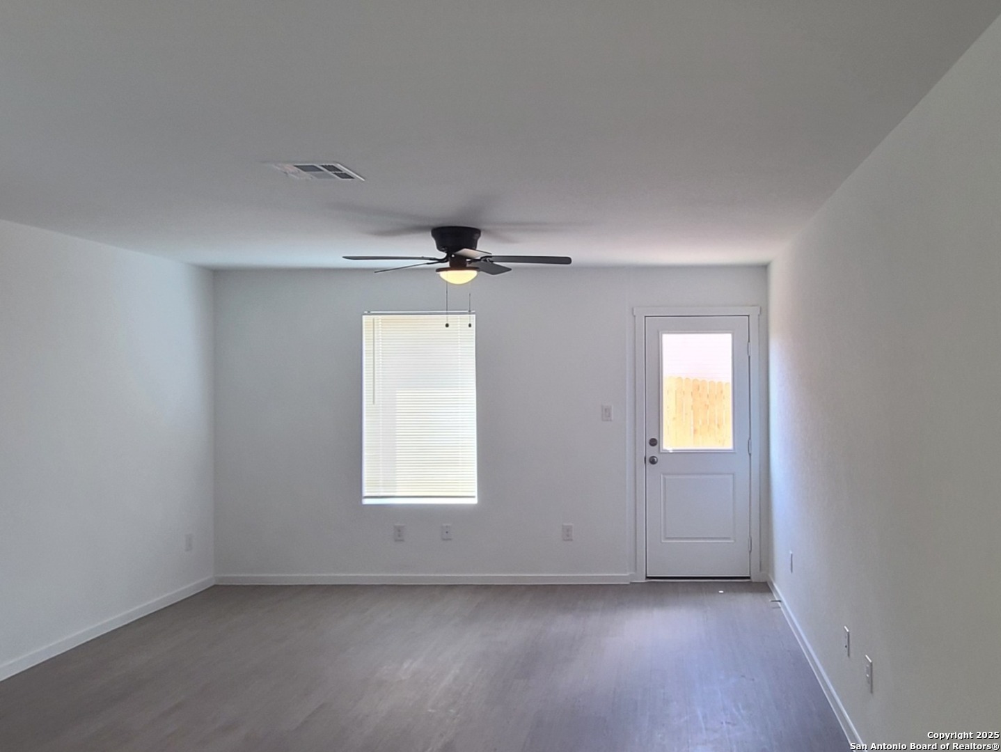 4965 Daisy Blossom Converse, TX 78109 - Photo 9 of 23 an empty room with a window and wooden floor