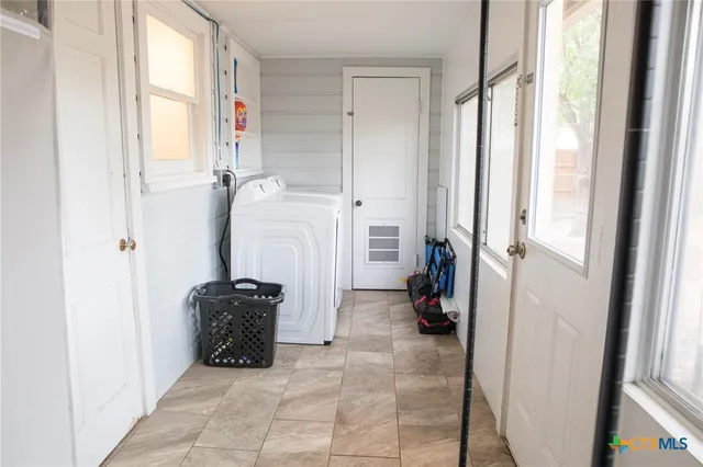 a view of a storage & utility room with a window