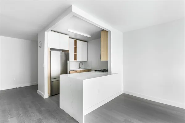 a kitchen with a refrigerator sink and cabinets