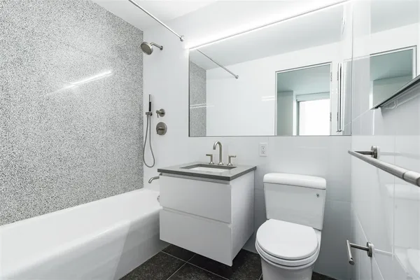 a bathroom with a toilet a sink and bathtub