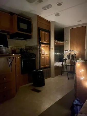 a kitchen with refrigerator and window