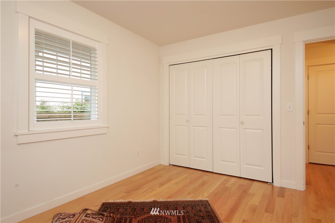 1813 Watkins Road Freeland, WA 98249 - Photo 21 of 29 a view of an empty room with wooden floor and a window
