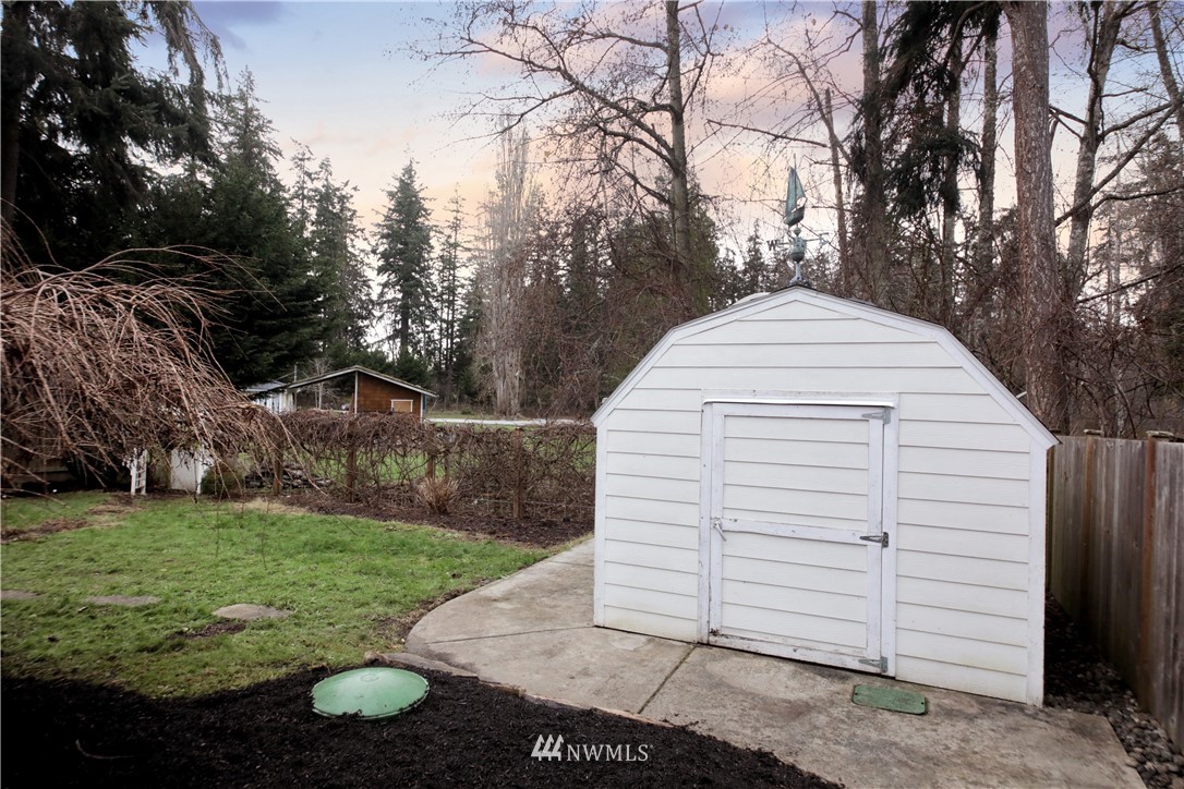 1813 Watkins Road Freeland, WA 98249 - Photo 26 of 29 a view of a white house with a yard