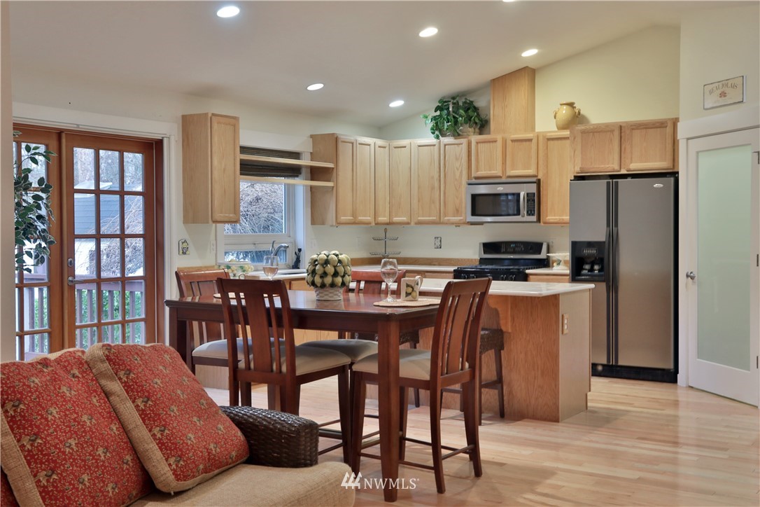 1813 Watkins Road Freeland, WA 98249 - Photo 5 of 29 a kitchen with stainless steel appliances kitchen island granite countertop a refrigerator and a stove top oven