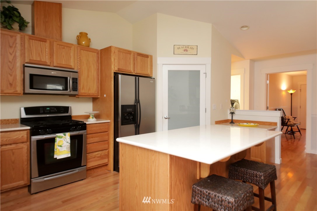 1813 Watkins Road Freeland, WA 98249 - Photo 7 of 29 a kitchen with stainless steel appliances a stove microwave and refrigerator