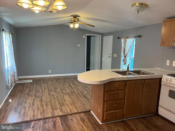 a kitchen with a sink appliances and cabinets