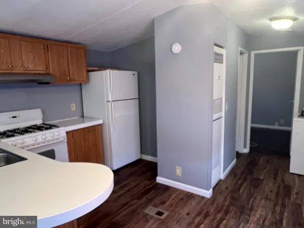a kitchen with a refrigerator and a stove