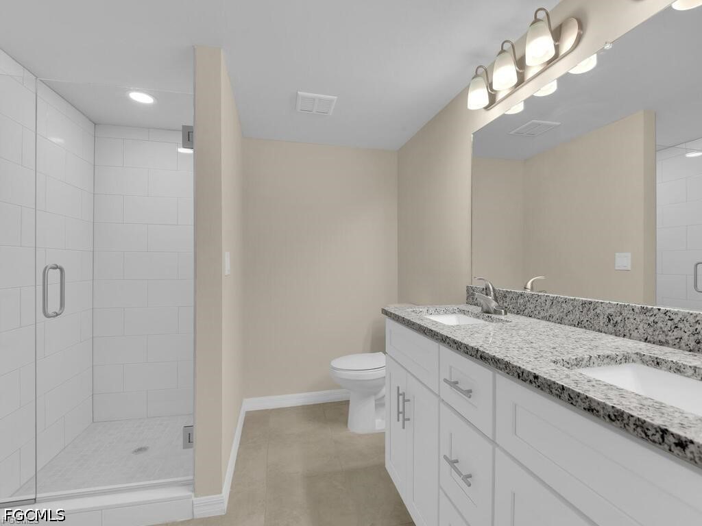16560 Partridge Place Road, Unit 101 Fort Myers, FL 33908 - Photo 13 of 27 a bathroom with a granite countertop sink a toilet and shower