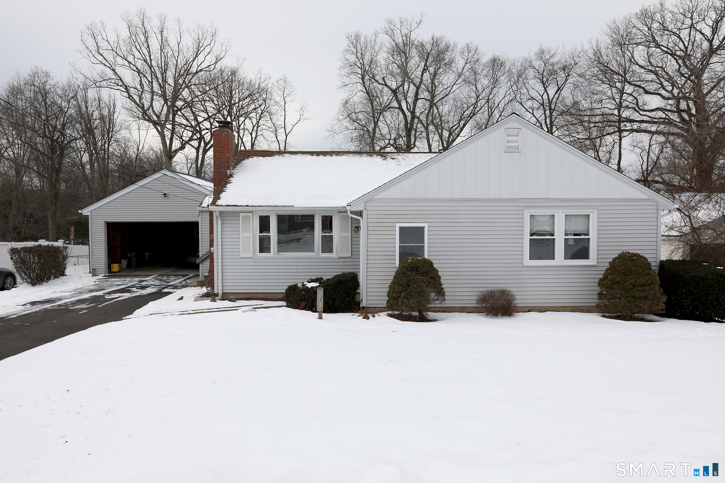 819 Matianuck Avenue Windsor, CT 06095 - Photo 1 of 1 a front view of a house with a yard covered in snow