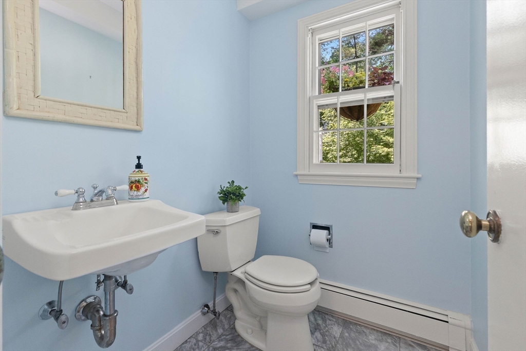 73 High Ridge Road Boxford, MA 01921 - Photo 8 of 39 a white toilet sitting next to a bathroom sink