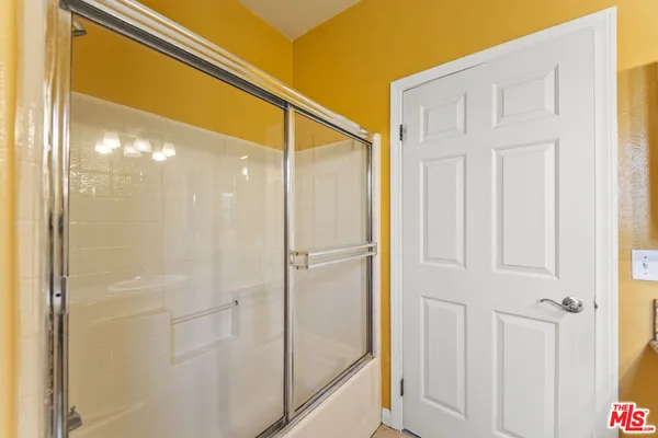 a bathroom with a glass shower door