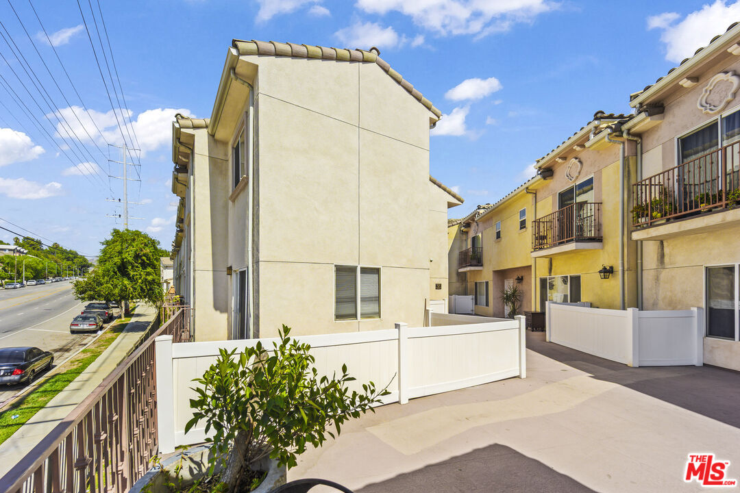 12375 Osborne Place, Unit 13 Pacoima, CA 91331 - Photo 31 of 37 a view of residential house with wooden fence