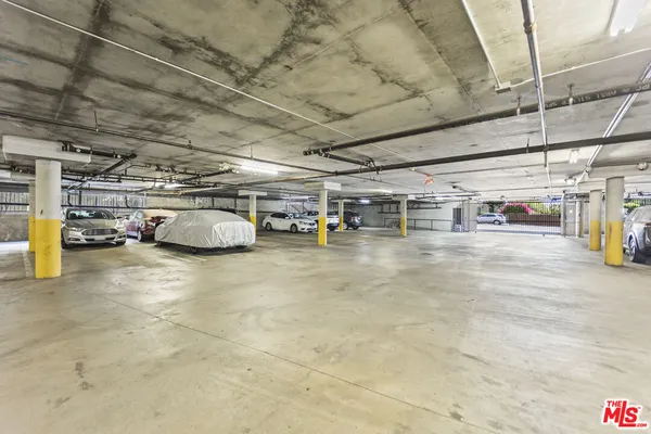 a view of parking garage with cars