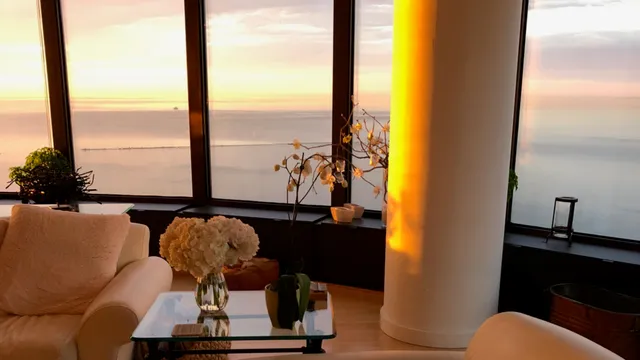 a living room with furniture and a floor to ceiling window