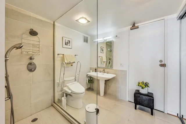a white toilet sitting next to a bathroom sink