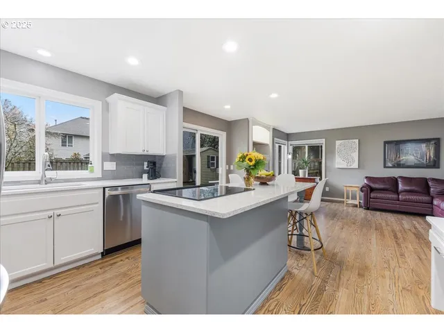 a kitchen with counter top space a sink cabinets and appliances