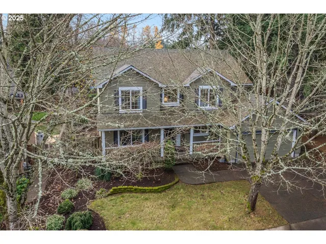 a aerial view of a house with yard porch and furniture