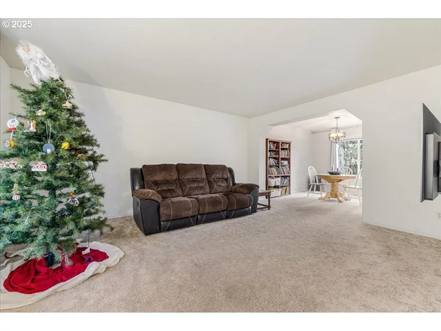 a living room with furniture and flowers