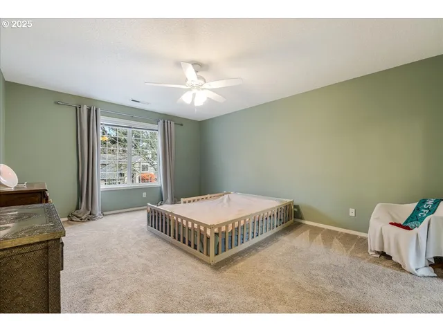 a living room with a baby crib furniture and a chandelier