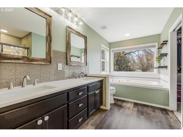 a bathroom with a sink and a large mirror