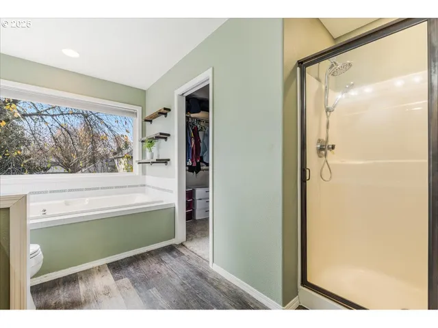 a bathroom with a bathtub and a shower
