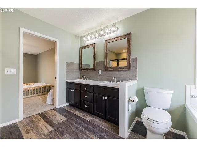 a bathroom with a toilet a sink and mirror