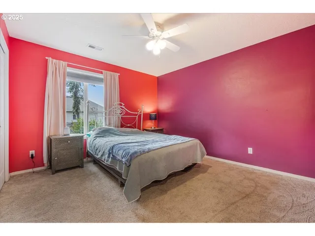 a bedroom with a bed and a ceiling fan