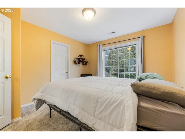 a bedroom with a bed and a window