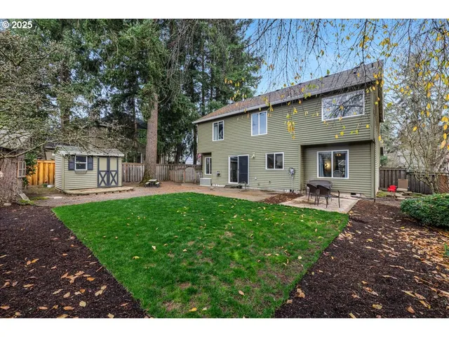 a view of a house with backyard and sitting area
