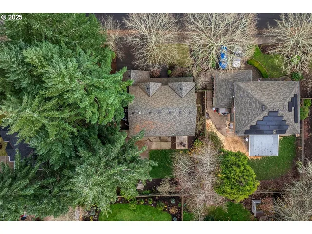 a aerial view of a house with a yard and trees