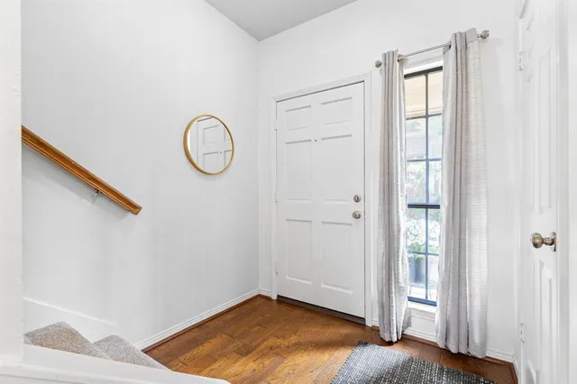 a view of room with wooden floor and bathroom