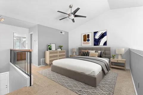 a bedroom with a bed and a chandelier